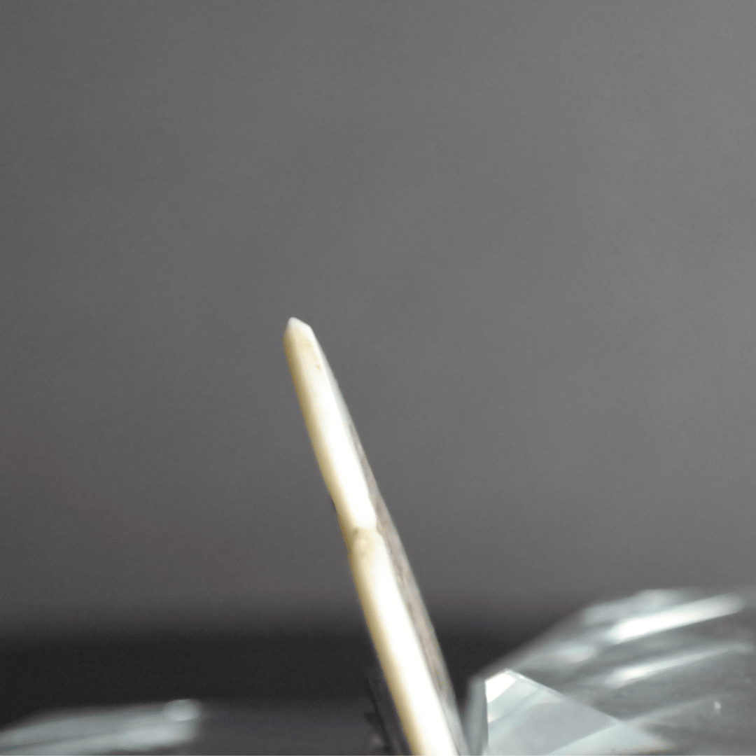 A Knc Picks handmade 2.0mm bone guitar pick featuring a detailed, laser-engraved Samurai Katana sword design.