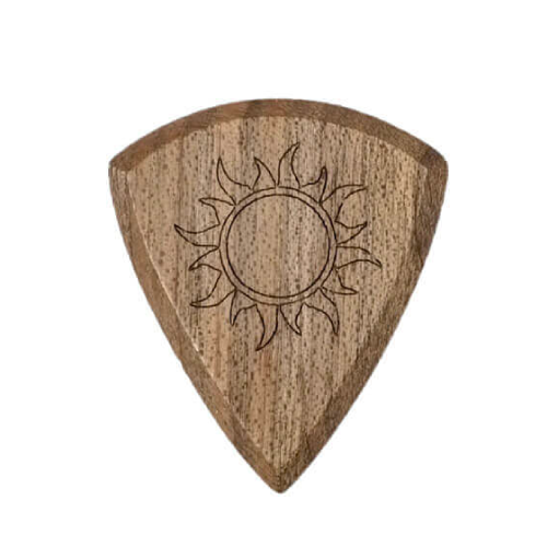 Close-up macro detail of the 'Burning Sun' engraving on a natural wood guitar pick.