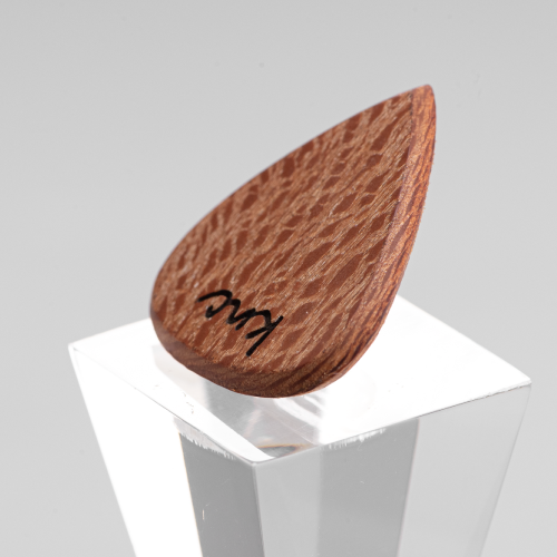 A personalized Lacewood pick with a custom logo laser-engraved over the intricate speckled grain.