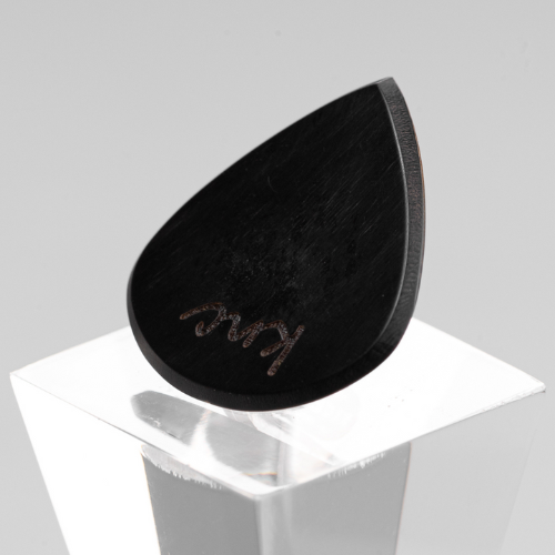 A personalized 'Lil One' Ebony pick with a custom name laser-engraved on the small, black wood surface.
