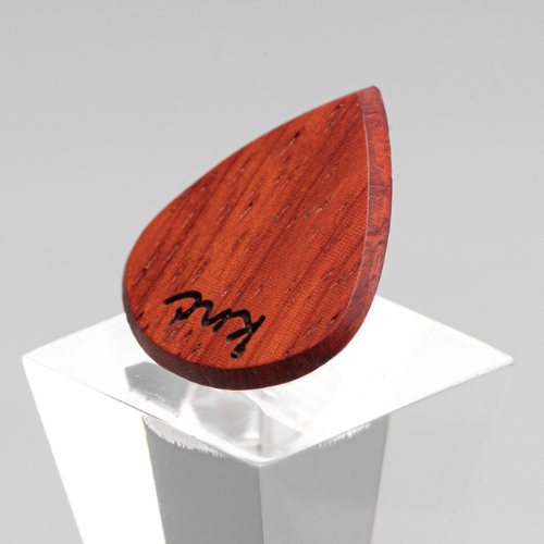 A personalized 'Lil One' Padouk pick with a custom name laser-engraved on the small surface.