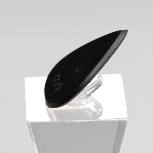 A macro close-up of the Ebony pick, detailing the polished, dense black wood grain.