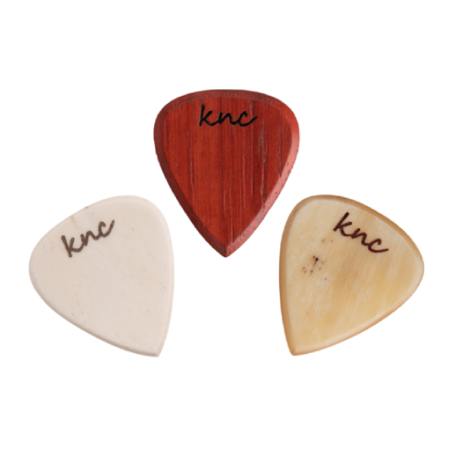 The three handmade wooden picks from the Blues Set, showing different Blues-themed designs (e.g., harmonica, delta guitar).