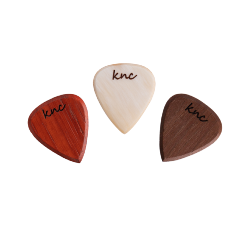 The three handmade wooden Jazz picks (e.g., Maple, Walnut, Ebony), showing their small, sharp, precision shape.