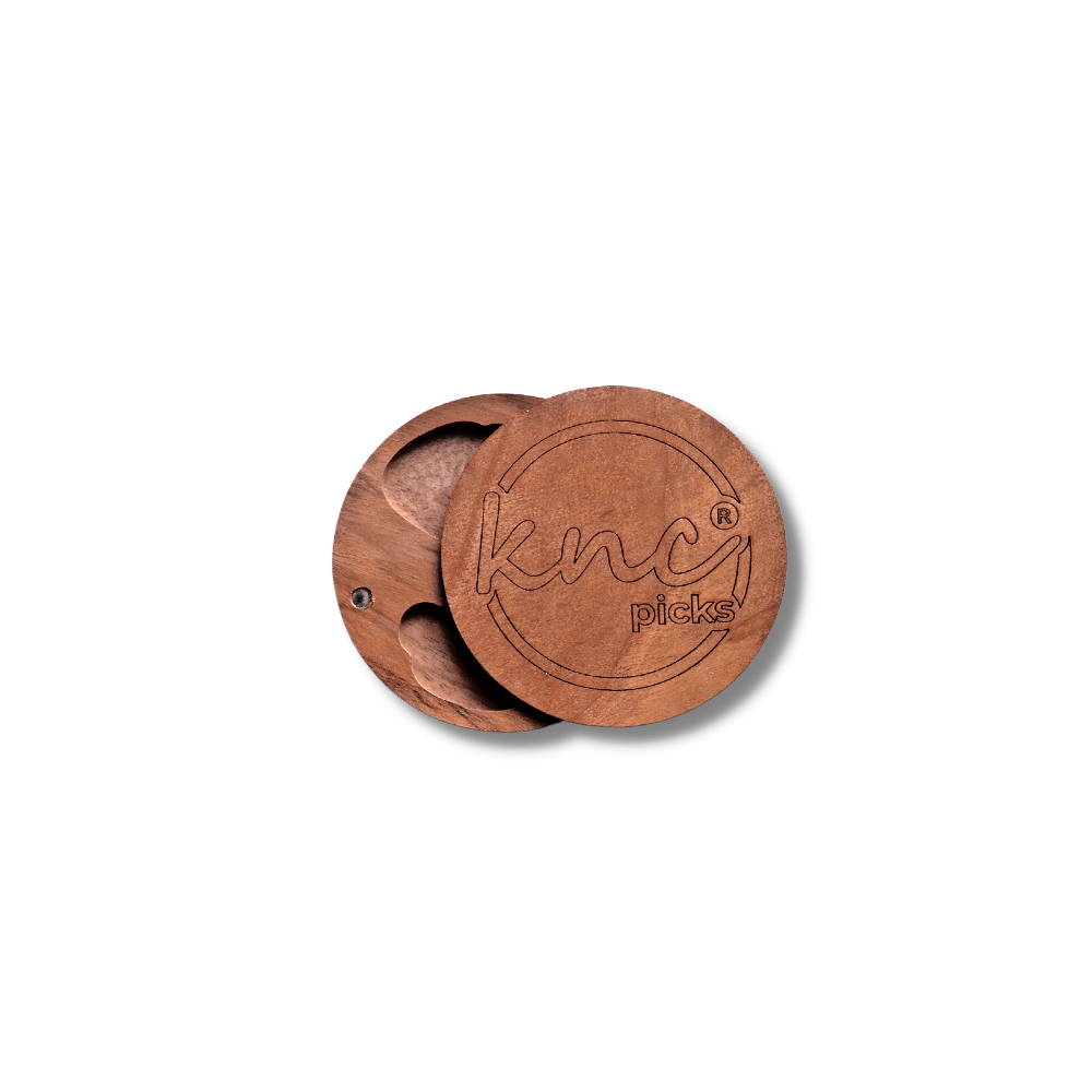The Knc Picks 3-Piece Wooden Pick Box (pick case), showing its natural wood grain and the engraved Knc logo on the lid.