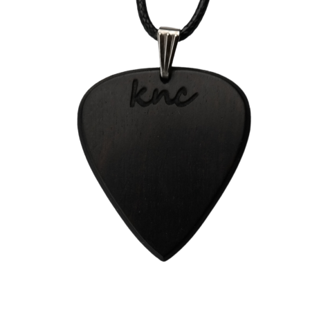 A handmade Knc Picks Ebony wood guitar pick, showing its pure black color, attached to a durable necklace chain.