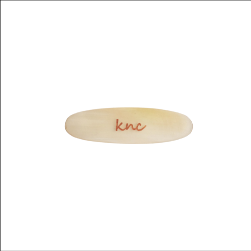 A Knc Picks handmade horn Bağlama tezene (Saz plectrum) showing its unique natural color pattern and durable structure.