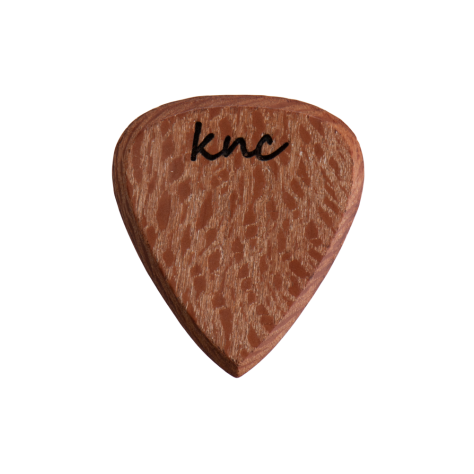A handmade Knc Picks guitar pick crafted from natural Sycamore (Lacewood), showing its unique, speckled 'lacy' grain pattern.