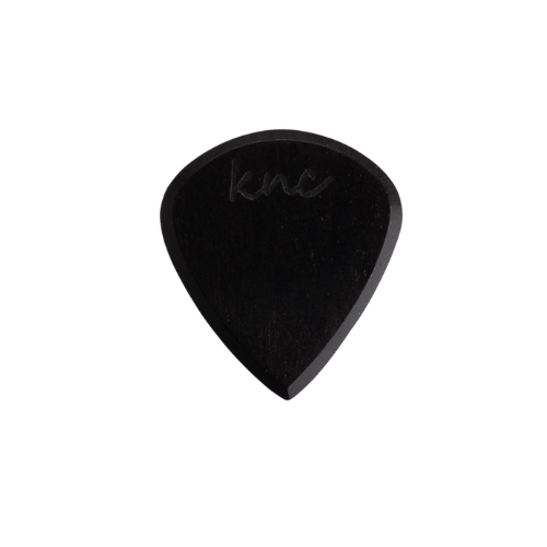 A Knc Picks handmade 'Lil One' (Jazz-style) guitar pick, crafted from natural pure black Ebony wood, highlighting its small, sharp shape.