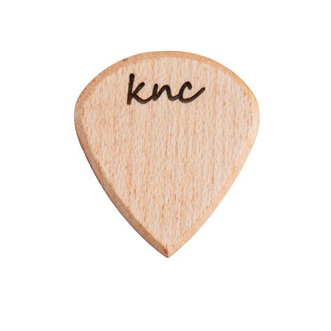 A Knc Picks handmade 'Lil One' (Jazz-style) guitar pick, crafted from natural light-colored Maple wood, highlighting its small, sharp shape.