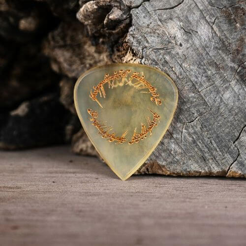 A Knc Picks handmade natural horn pick laser-engraved with the 'One Ring' script (Tengwar) from Lord of The Rings.