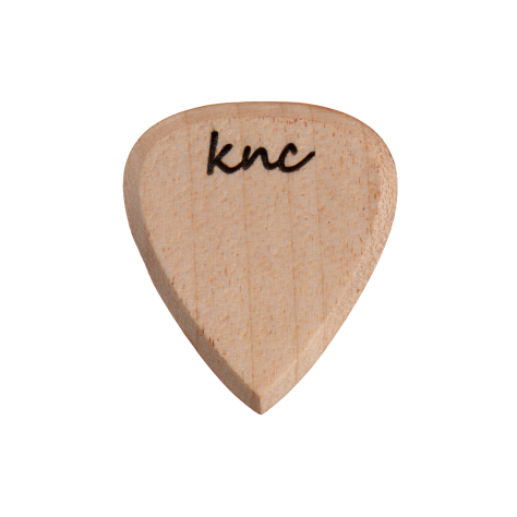 A handmade Knc Picks guitar pick crafted from natural Maple wood, showing its light, creamy color and smooth grain