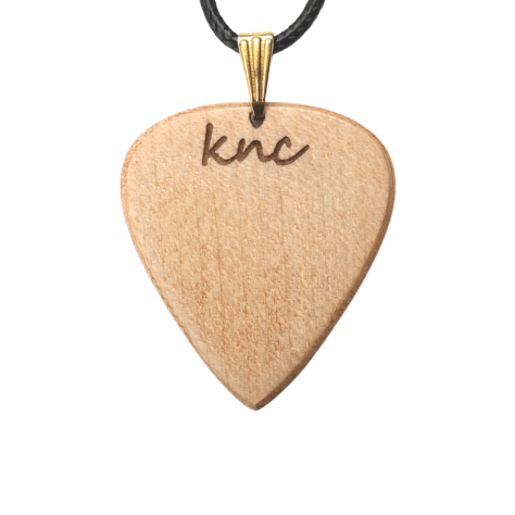 A handmade Knc Picks Maple wood guitar pick, showing its light color, attached to a durable necklace chain.