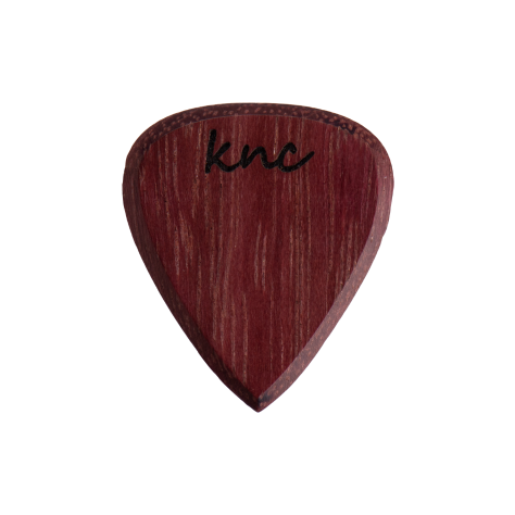 A handmade Knc Picks guitar pick crafted from natural Purpleheart (Morkalp) wood, showing its deep, vibrant purple color.