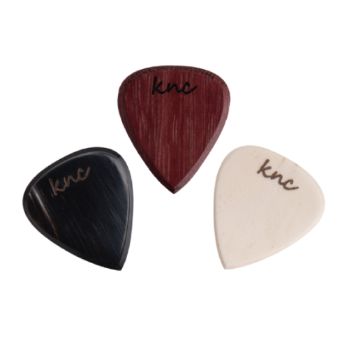 set of three handmade wooden guitar picks from the Knc Picks Rock Series, showing different rock-themed designs.