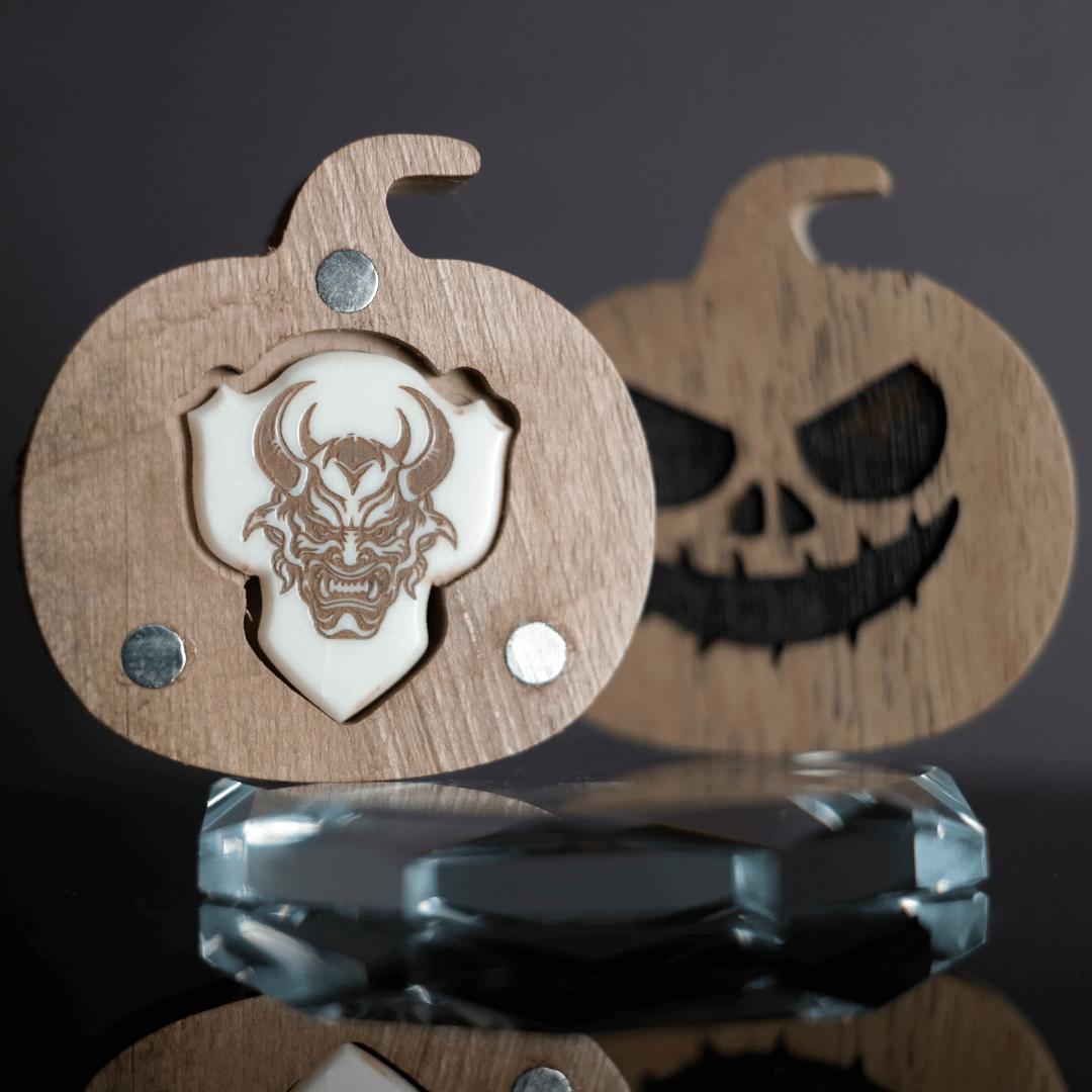 A Knc Picks handmade 2.0mm bone guitar pick featuring a detailed, laser-engraved Samurai Katana sword design.