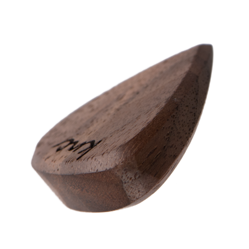 A Knc Picks 'The Boss' Series guitar pick, handmade from natural walnut wood, showing its special ergonomic shape for fast playing.