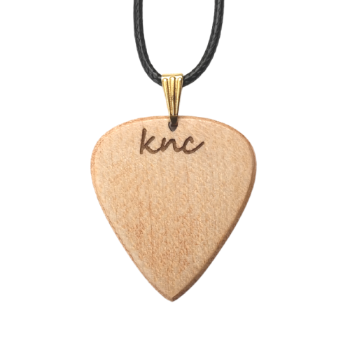 Close-up detail of the natural light wood grain of the Maple pick used for the necklace.