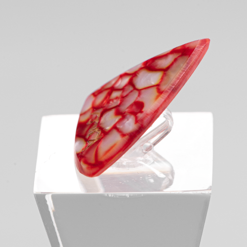 Close-up detail of the natural pearlescent red swirls of the Galalith (Casein) material on the pick.