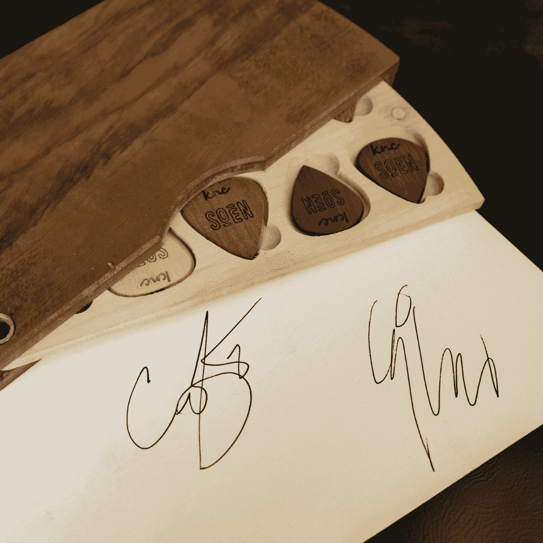 The SOEN Limited Edition Signature Pick Set by Knc Picks, showing 10 natural material picks with the SOEN logo inside a premium wooden collector's box.
