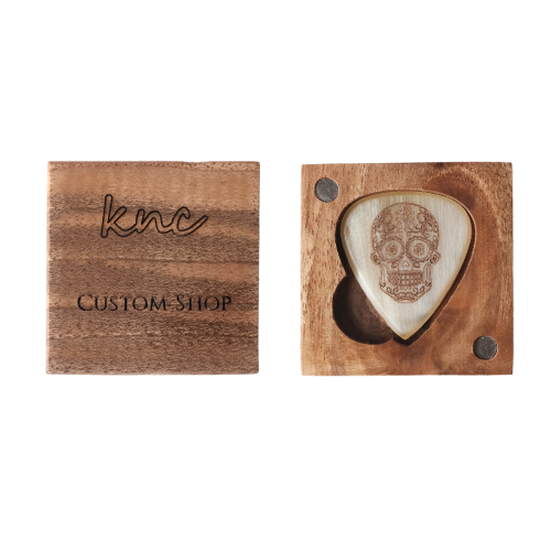 The 'Sugar Skull' horn pick presented in its optional Knc Picks premium wooden gift box.