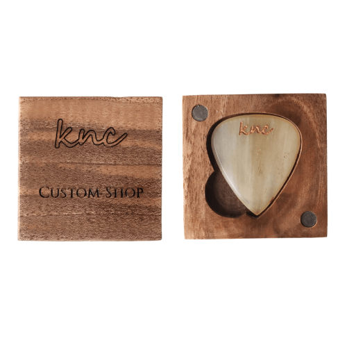 "Close-up macro detail on the variegated natural horn material (yellows, browns, blacks).