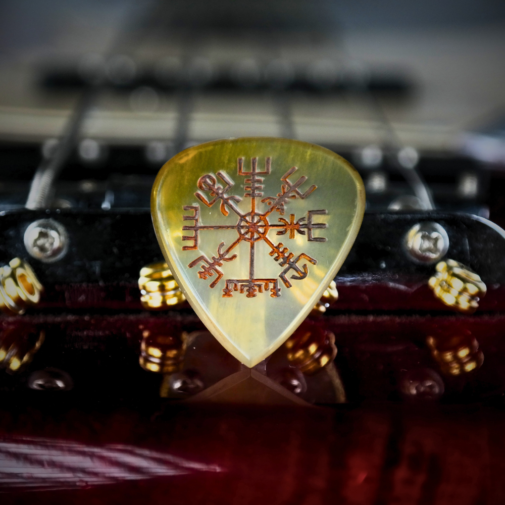 The Vegvisir engraved horn pick shown next to its optional handcrafted wooden gift box from Knc Picks.