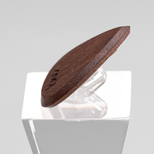 A macro close-up of the Walnut pick, detailing the rich, dark natural wood grain.